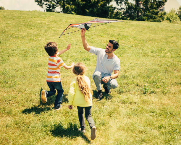 istock Father flying a kite with his children 805089374