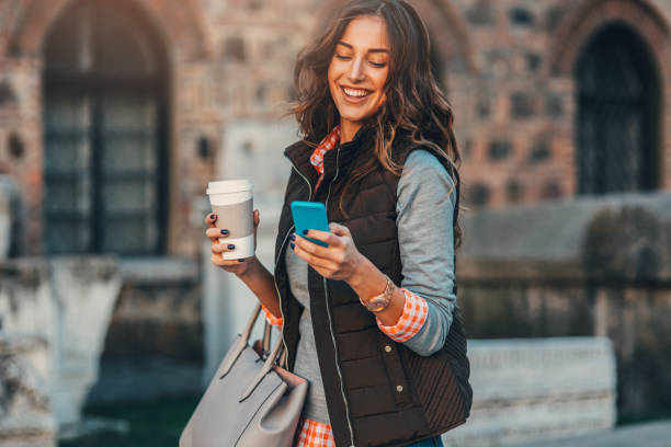 istock Woman texting and drinking coffee outdoors. 805089402