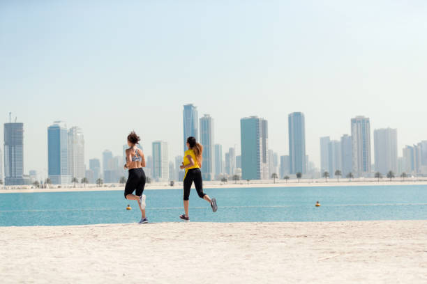 istock Women jogging with cityscape in background 805124484