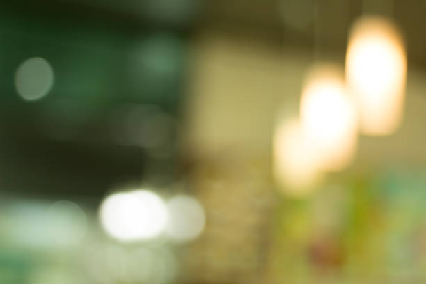 Lights blurred bokeh background in coffee shop.