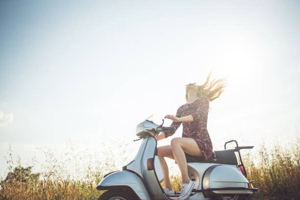 Enjoying the summer on motorbike Young woman sitting on the motorcycle on the countryside moped stock pictures, royalty-free photos & images