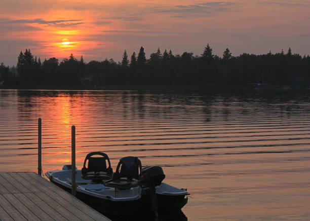 istock Small boat docked on a lake at sunset. 805148344