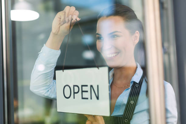 istock Woman holding open sign in cafe 805150972