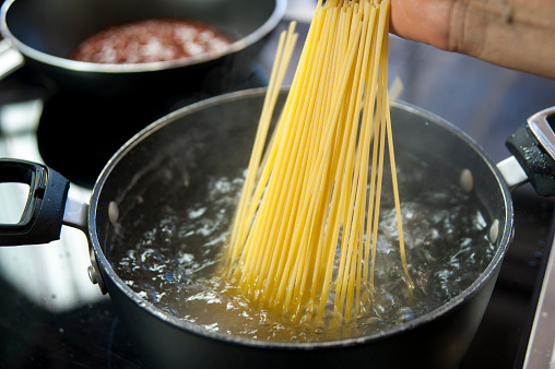 Cooking spaghetti in a pot with boiling water