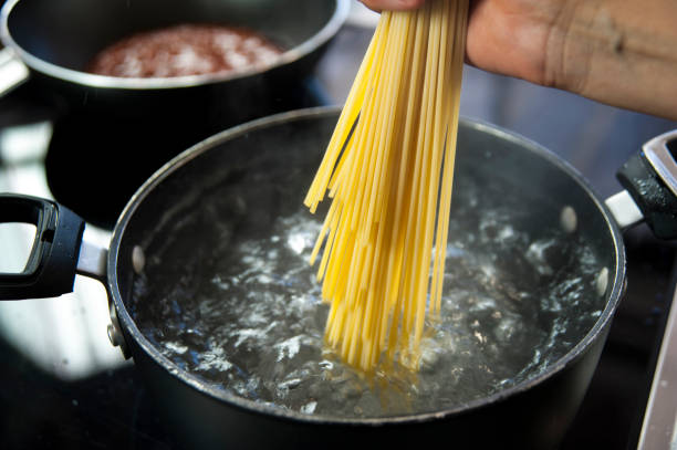 istock Cooking spaghetti in a pot with boiling water 805157608