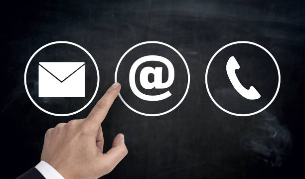 istock Hand pointing at contact options icons e-mail letter telephone 805170982