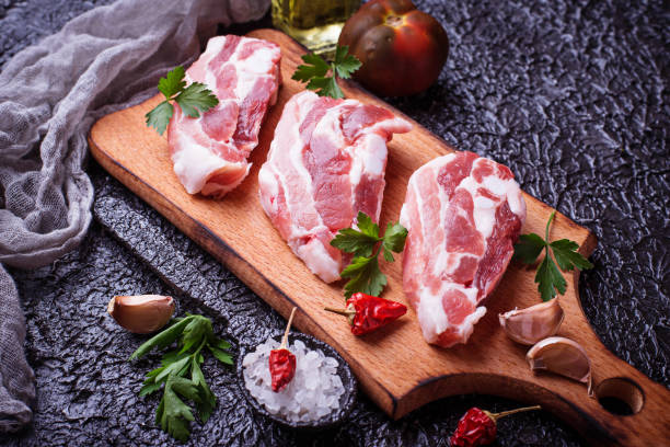 istock Raw pork meat and ingredients for cooking 805184432