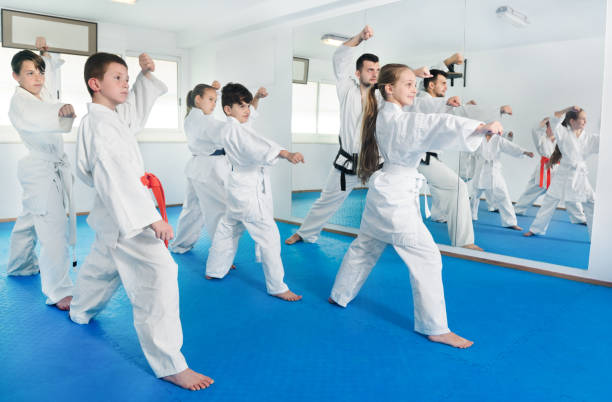 istock Children trying martial moves in karate class 805189024