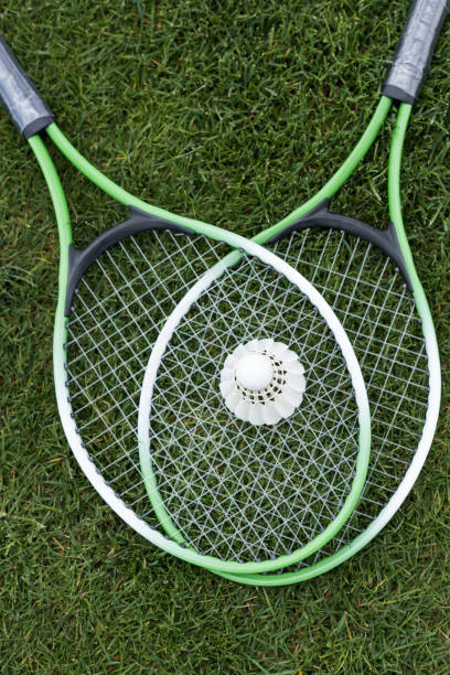 istock top view of shuttlecock on badminton rackets lying on green grass 805189122