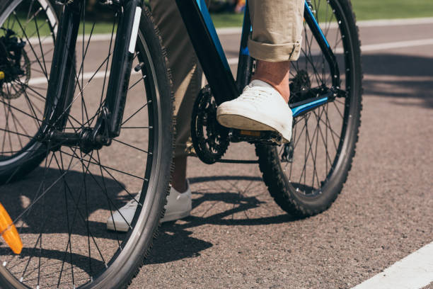 istock partial view of man riding bicycle in summer park 805197648