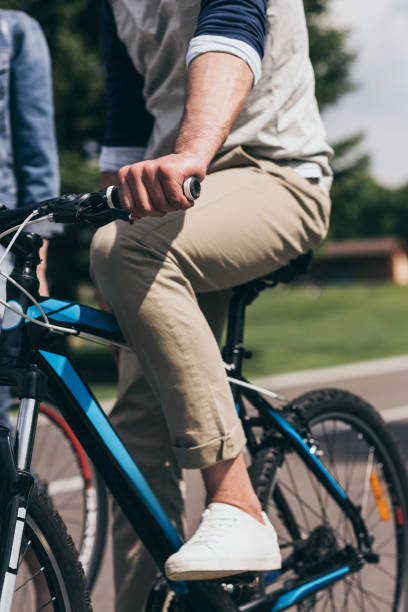 istock partial view of man riding bicycle in summer park 805198122