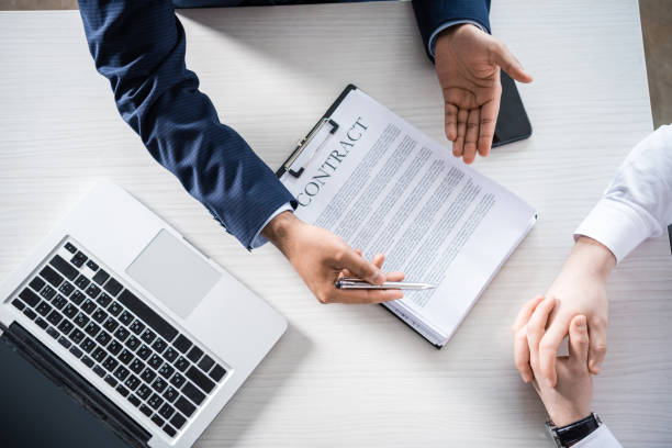 istock top partial view of businessmen discussing contract at workplace 805206890