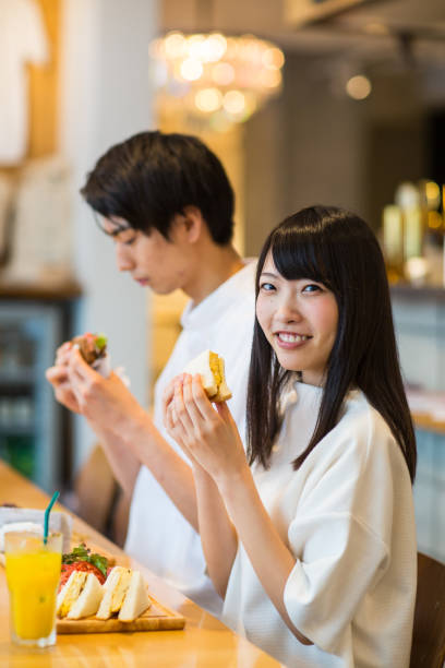 istock Young couple enjoying lunch together in a cafe 805211230