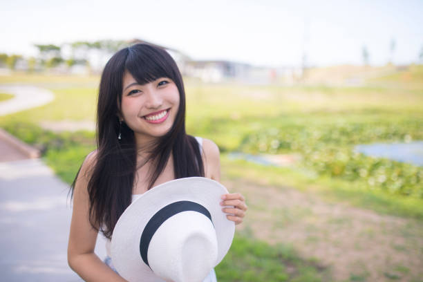 Happy young woman walking in public park