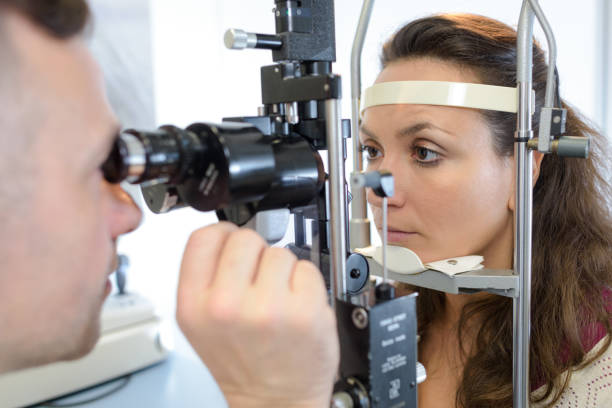istock woman doing eye test in optical clinic 805220440