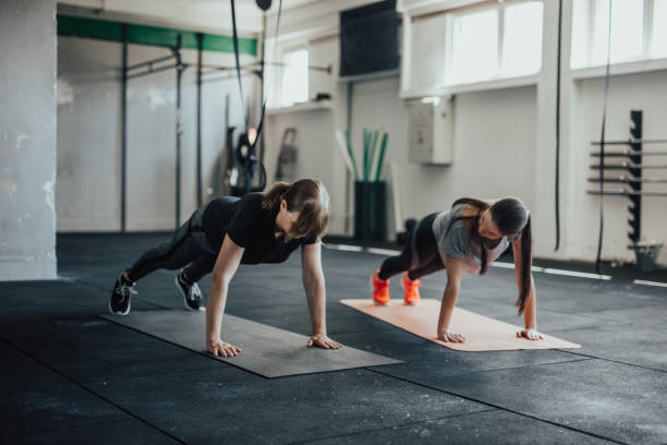 istock Two women in plank pose at the gym. 805220488