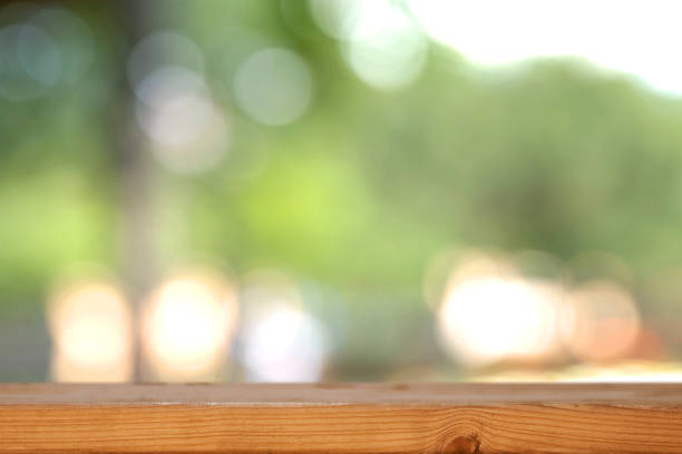 istock Wooden board empty table blur in nature background 805220508