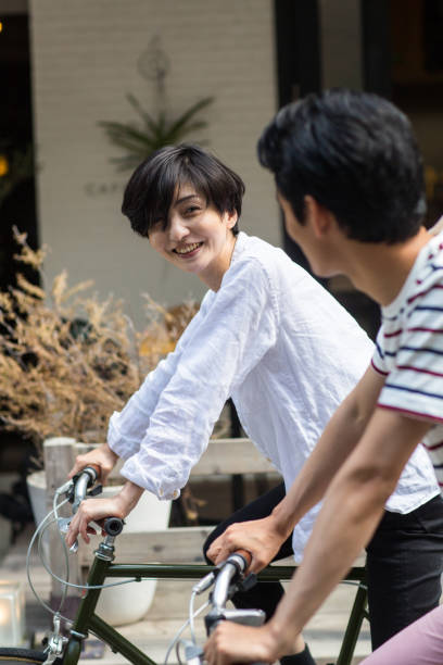 istock Young couple riding bicycles in an urban setting 805225054