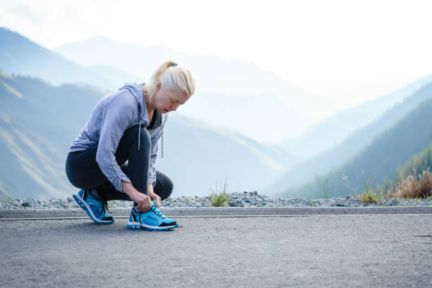 istock Sport runner woman tying laces before training. Marathon. 805226788