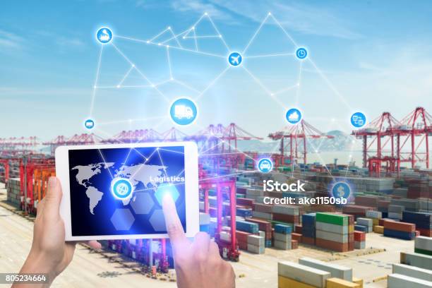 Hand Holding Tablet Is Pressing Button Logistics Connection Technology Interface Global Partner Connection For Logistic Import Export Background Business Logistics Concept Internet Of Things Stock Photo - Download Image Now
