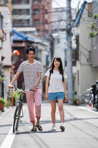 istock Man walking with a woman and pushing his bicycle 805248502