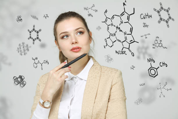 istock Woman chemist working with chemical formulas on grey background 805258046