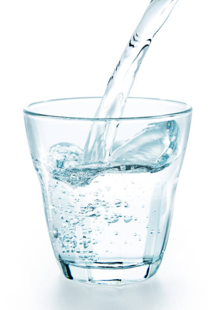 istock pouring fresh water in a glass 805259306
