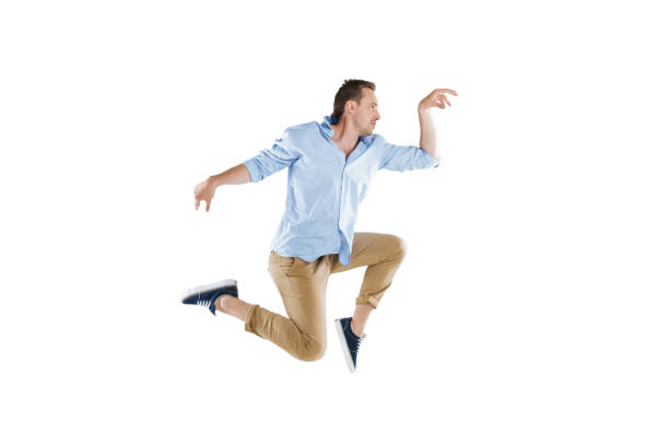 istock side view of young man jumping and looking away isolated on white 805269856