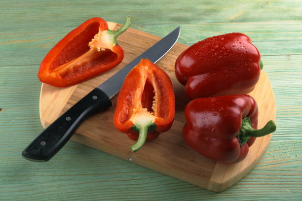 istock Red pepper on the wooden table. 805290988