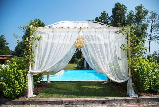 Wedding location - swimming pool and a gazebo with white curtains