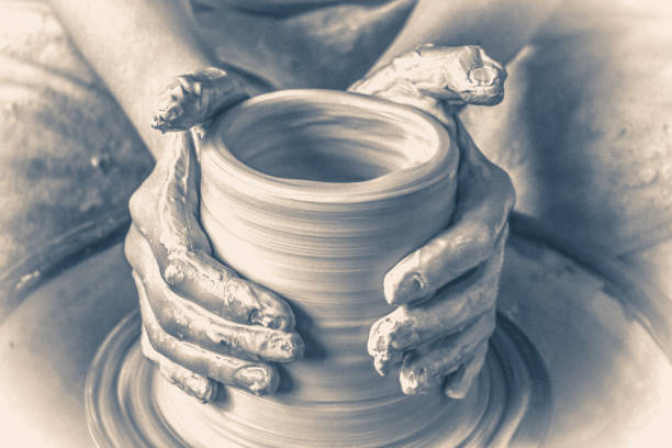 istock Old vinage style. Creating a jar or vase of white clay close-up 805299042