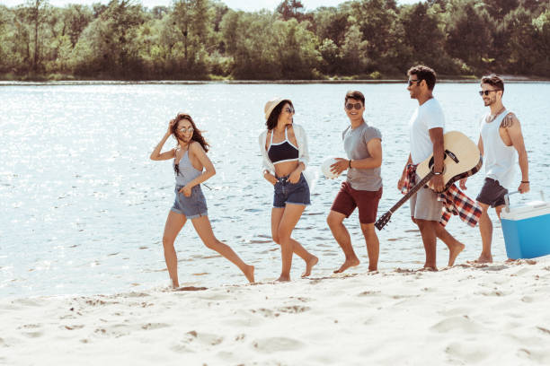 Premium Photo Happy friends playing guitar on the beach