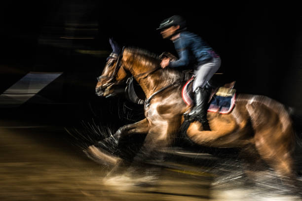 istock Blurred horse rider riding through a puddle 805307948