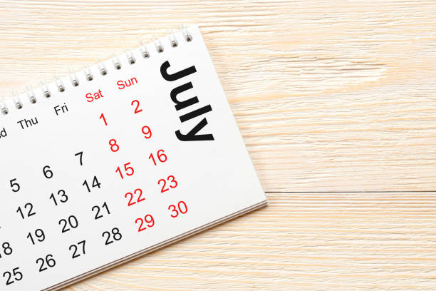 istock july 2017 calendar on white wooden planks 805308256