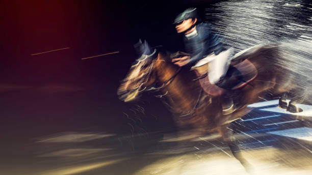 istock Blurred horse rider jumping through water 805309166