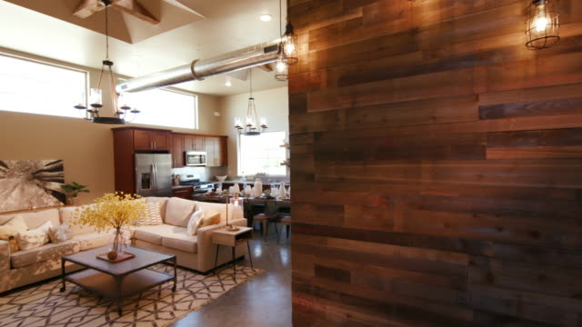 Wood Wall and Lights Panning and Lowering to Main Living Room Open Layout