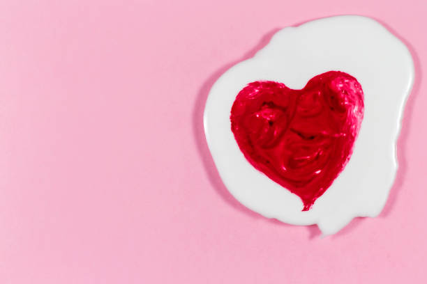 istock Blurred of heart in white cream with pink background. 805320656