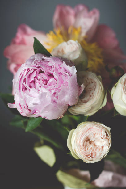istock Peonies and pink roses bouquet on black background 805320682