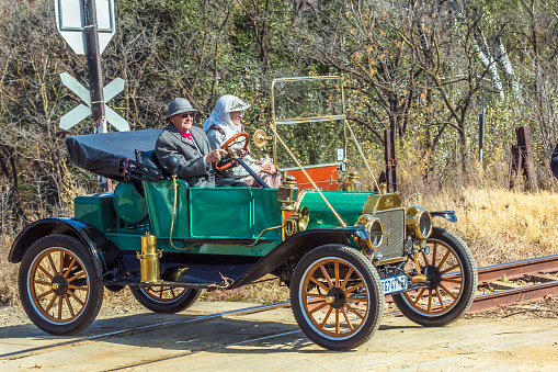 Ford Model T from the Vintage and Veteran Club of South Africa at a Vintage show in Magaliesburg with driver and passenger dressed to suit.