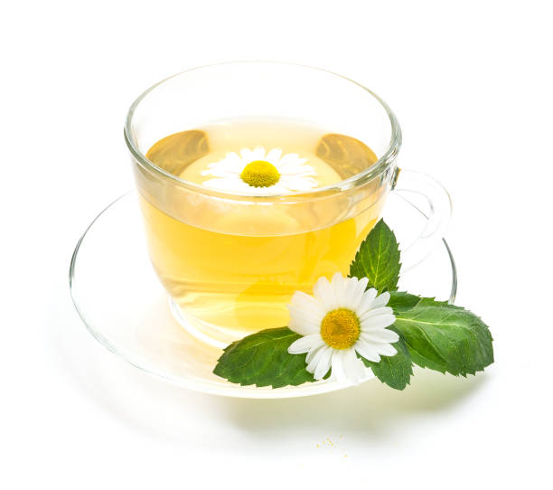 istock Transparent cup of chamomile tea with flowers and mint leaf 805417450