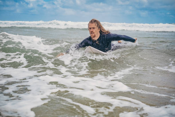 istock Surfer Paddling on his Surfboard, Towan Beach, Newquay, Cornwall. 805430698