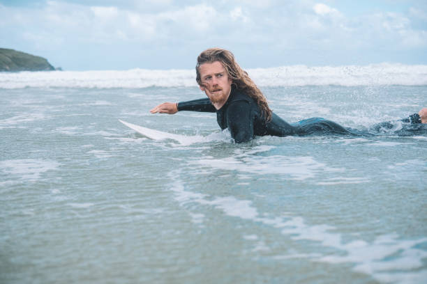 istock Surfer Paddling on his Surfboard, Towan Beach, Newquay, Cornwall. 805430768