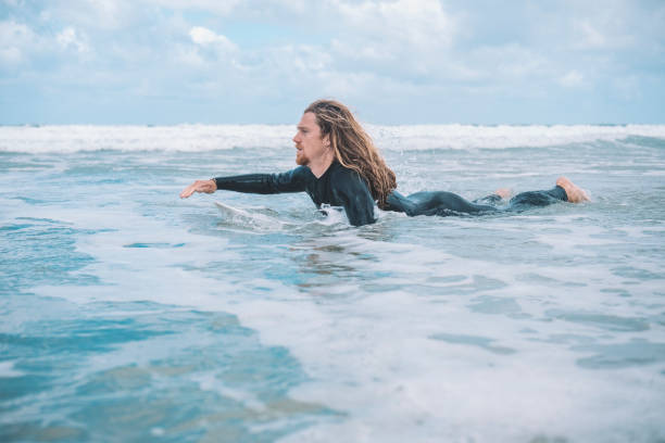 istock Surfer Paddling on his Surfboard, Towan Beach, Newquay, Cornwall. 805431082