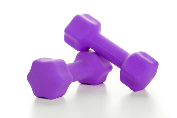 istock Fitness concept with two purple dumbbells on white background 805436748