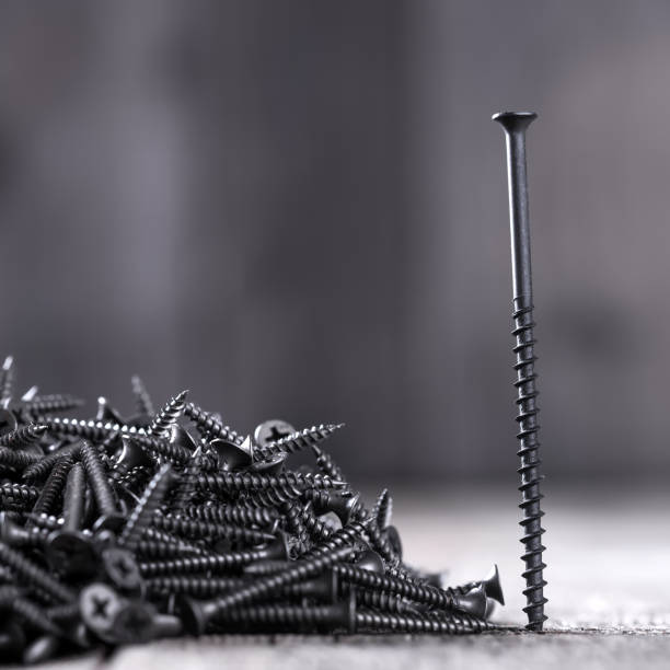 istock Pile of black screws 805437752