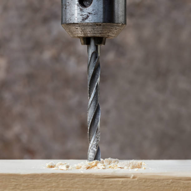 istock Drilling wooden plank with hand drill 805446872