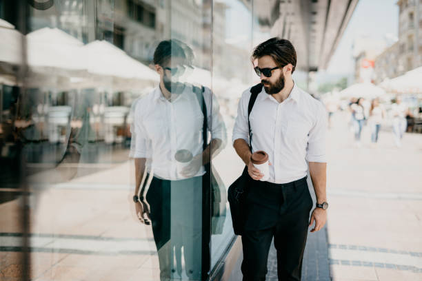 istock Office worker in front of the glass building. 805458498