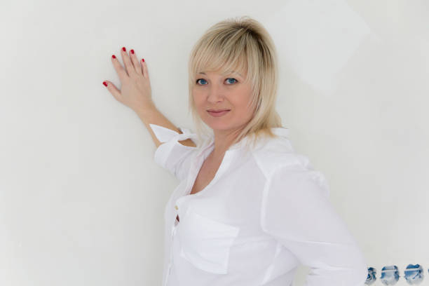 istock Blond woman with blue eyes in white 805467286