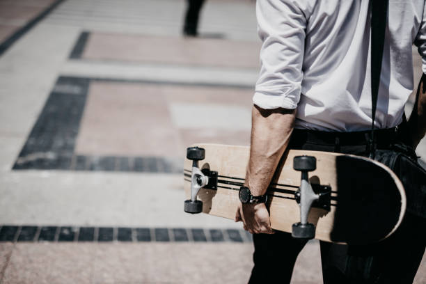 istock Rear view at modern businessman with skateboard. 805467440