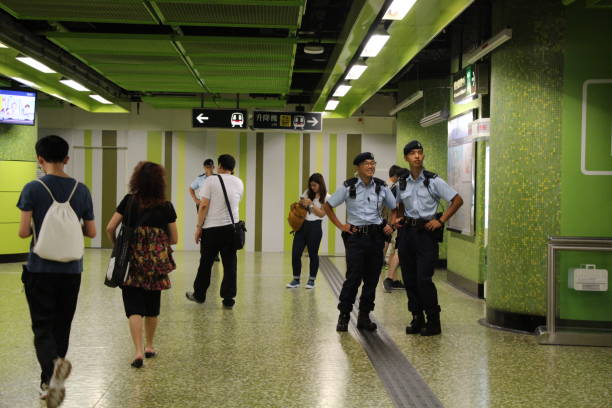 On the second day of President Xi Jinping's visit to Hong Kong, there is a very high level of security at Wan Chai underground station, full of police officers. Three uniformed police officers are seen in this photo in one area of Wan Chai underground (MTR) station. There are dozens more police officers on the same floor of this underground station. The number of police officers on duty at the station is much higher than usual. Wan Chai underground (MTR) station is very close to President Xi Jinping's sites of activities and the Grand Hyatt Hotel where he is staying. xi jinping stock pictures, royalty-free photos & images